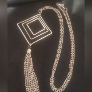 Long necklace chain tassel on a three tier square pendant. 24 inches long